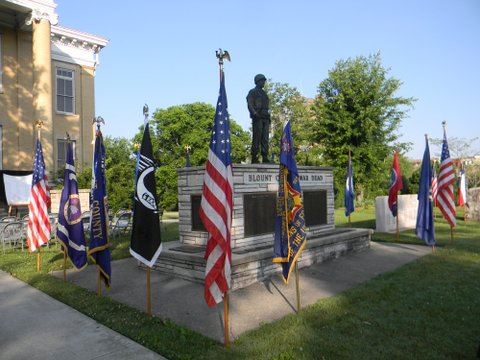 Image of the war memorial with surrounding flags, from the side